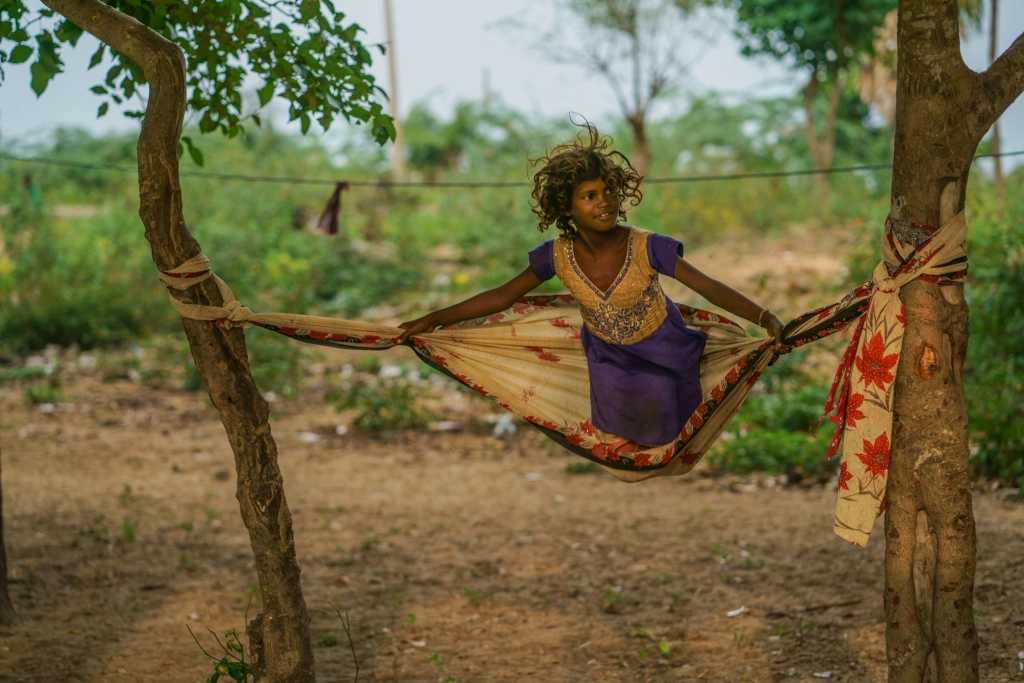 Usually the eldest girl in the family is thrusted  with her younger siblings. Children never been to school are a common category found in this Irular Colony.